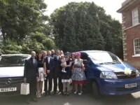 Family standing in front of Pams 2 mini bussesin Scunthorpe