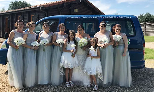 Wedding party standing in front of mini buses in Scunthorpe